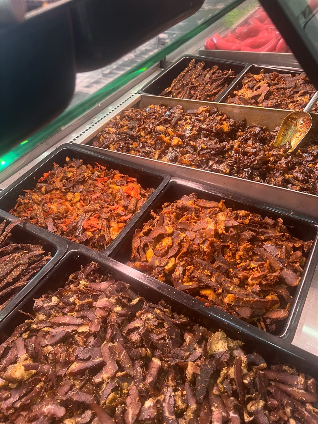 Close view of sliced biltong and beef sticks in the display counter